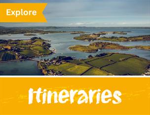 Image of Strangford Lough islands and the words Explore and Itineraries