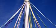 Maypole dressed with pastel coloured ribbons ready for the annual Maypole Dancing by local schoolchildren