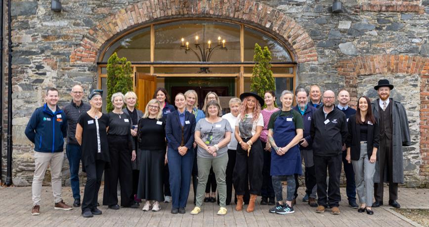 Image of all participants of the Loughs and Legends Cluster at the front doors of Clandeboye Estate 