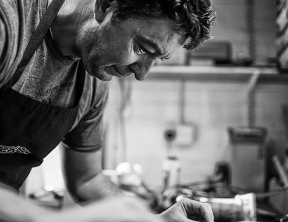 Photo showing a craftsman building a guitar from scratch