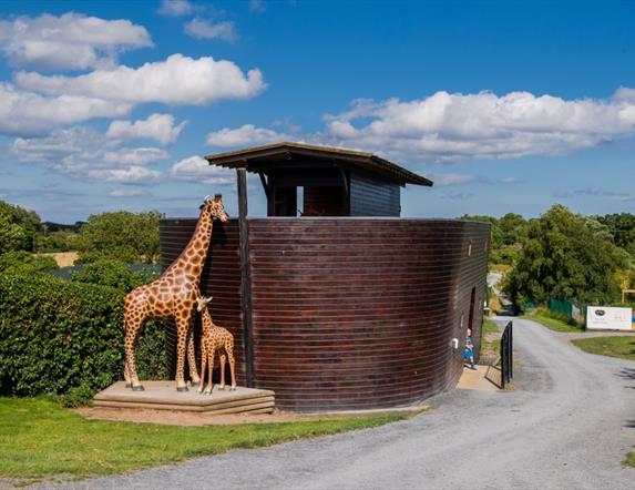 Image of the Ark Open Farm's small replica of Noah's Ark with animal statues including giraffe