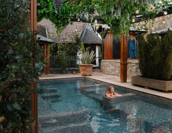 Blonde female in outdoor hot pool