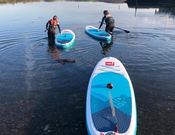 Paddle boarders setting out on the water
