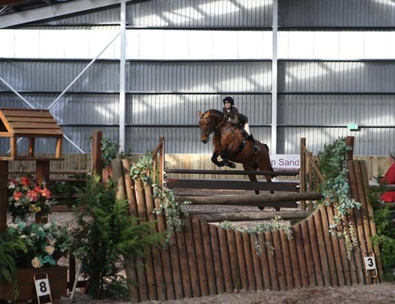 Horse and rider mid-jump