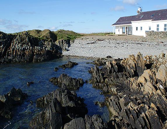 Back exterior with beach and rockshore