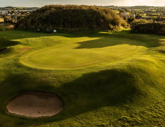 Silhouettes of golfers on the green