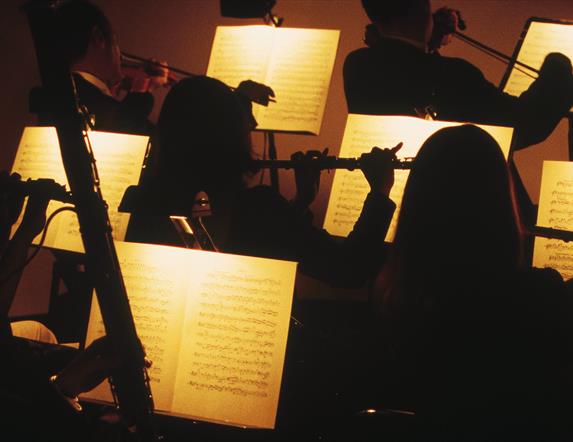 Orchestra players in silhouette