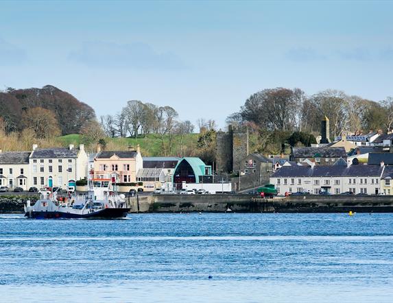A photo of the picturesque view of Portaferry town from Strangford Lough. The Strangford Ferry is in the shot.