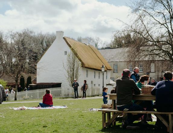 Visitors enjoying picnics in the grounds of the Folk Museum