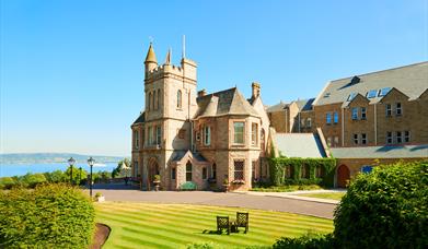 View of the hotel and landscaped grounds on a bright sunny day