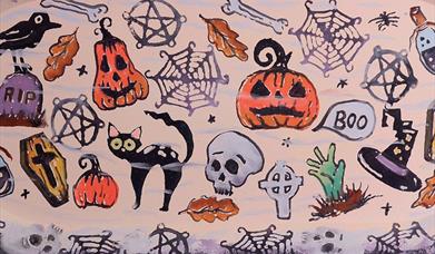 Pottery plate decorated with Halloween themed prints