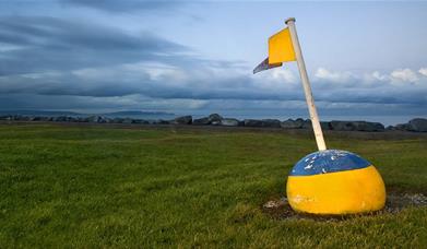 Photo of flagged bouy set out as decor at Ballyholme near the pitch and putt facility, overlooking the bay