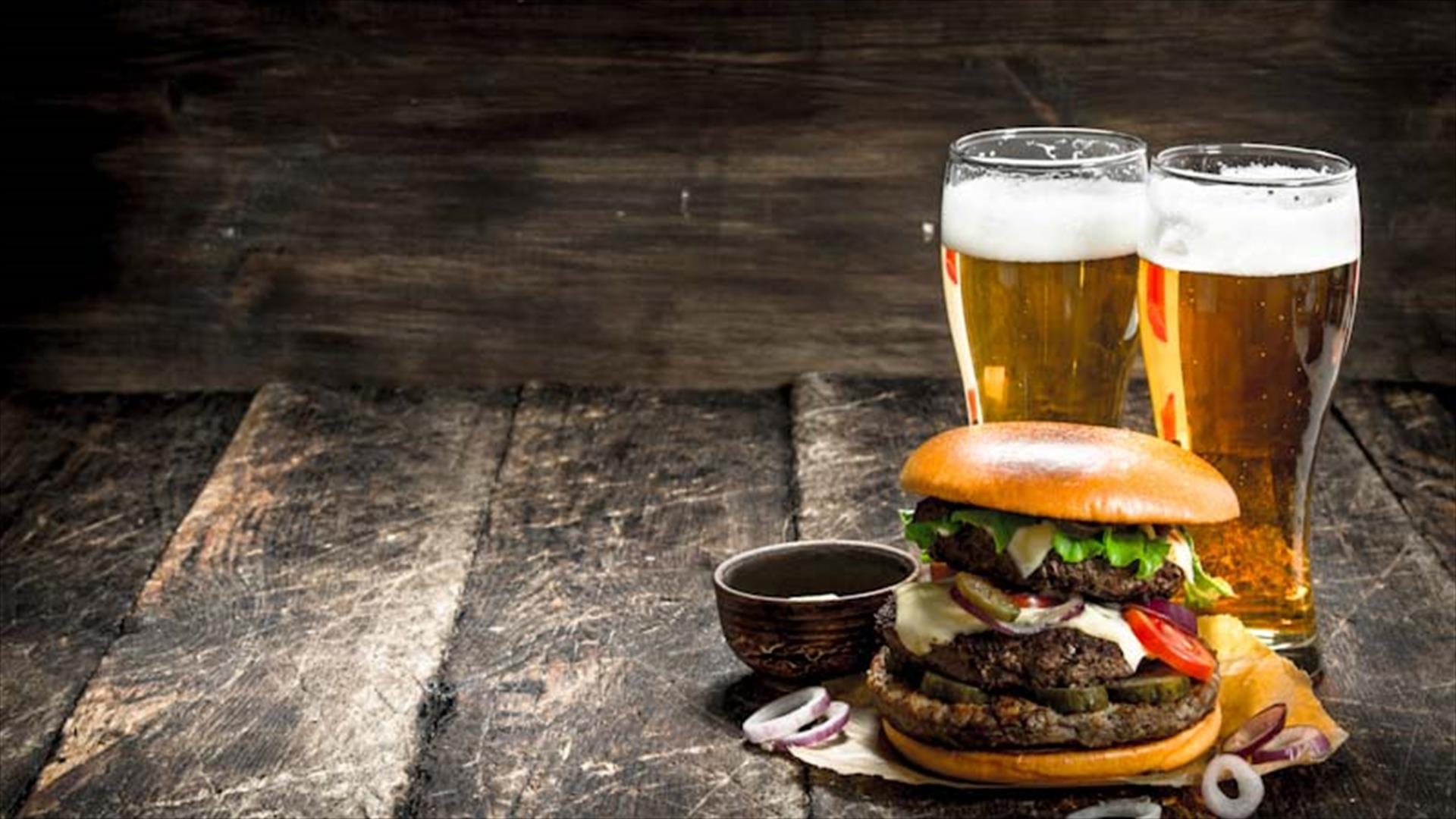 An image of two pints and a burger