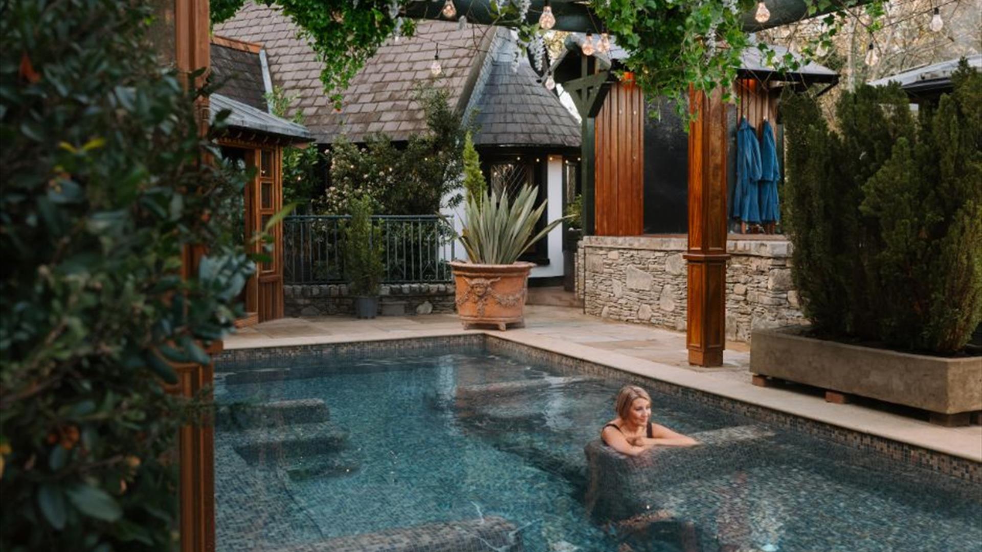 Blonde female in outdoor hot pool
