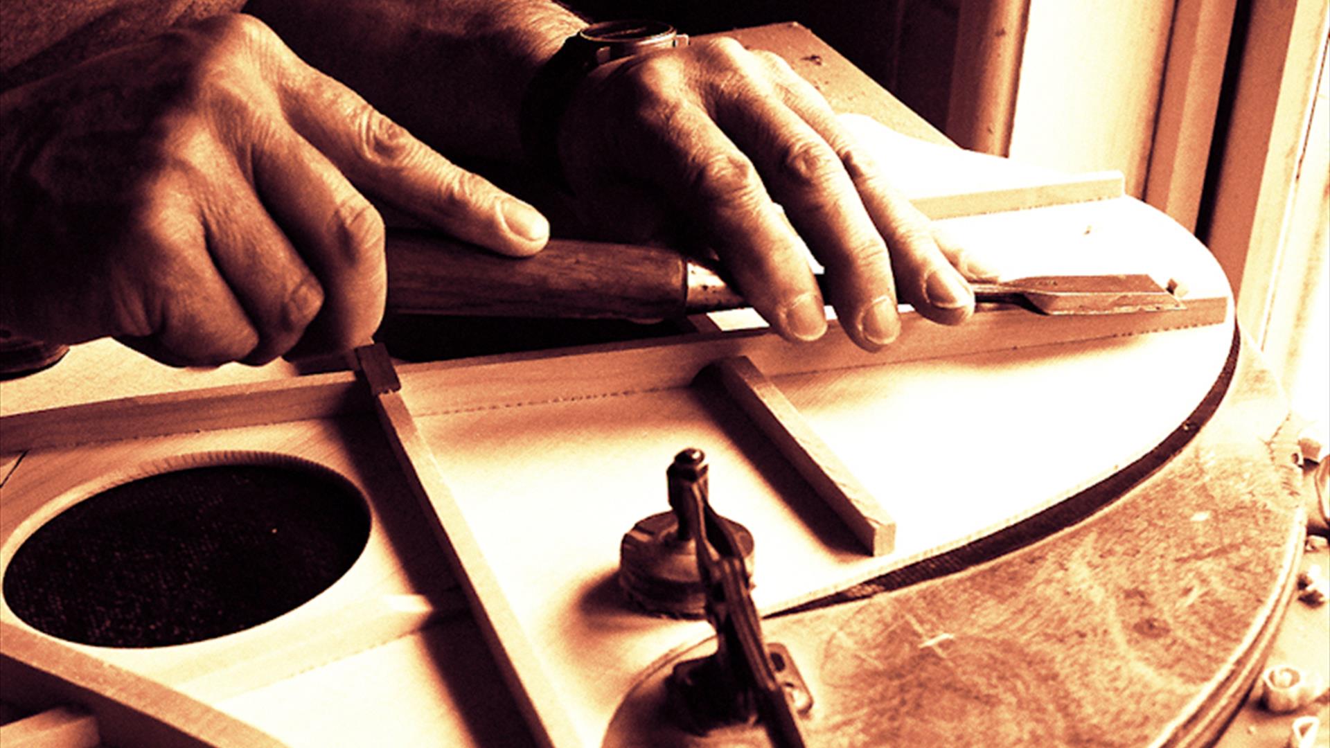 A luthier working on a guitar