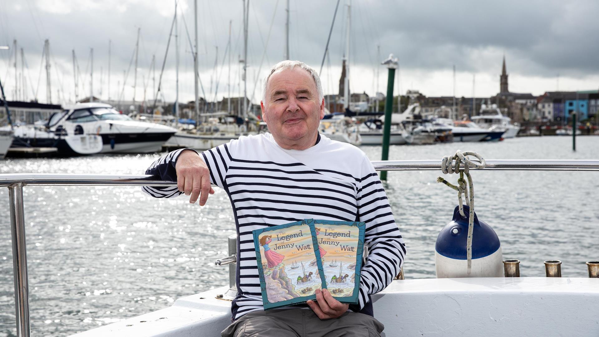 Skipper Brian Meharg poses with his book on Jenny Watts