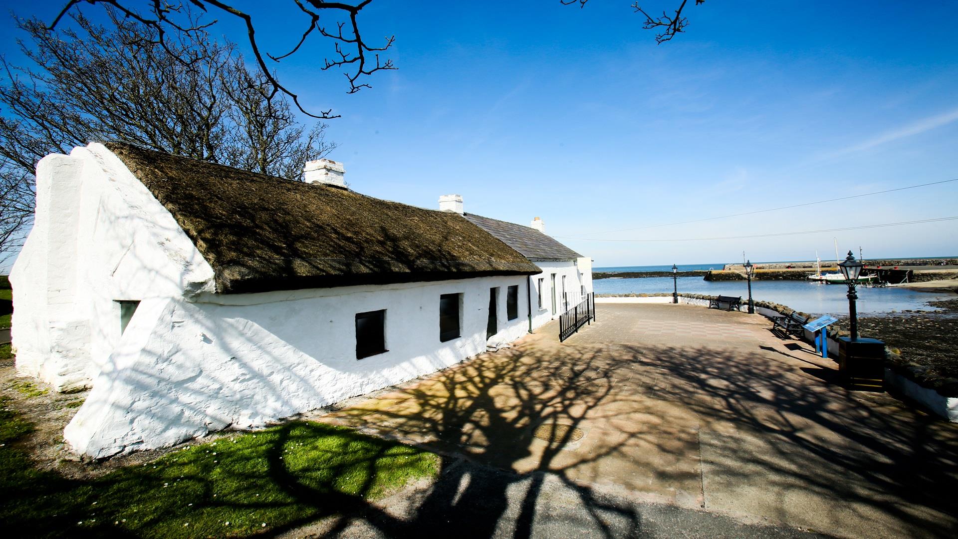 A close up photo of Cockle Row Cottages in Groomsport with a sense of location beside the harbour