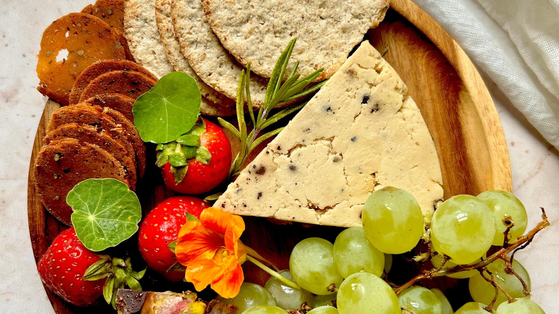 A selection of cheese, crackers, fruit and garnish