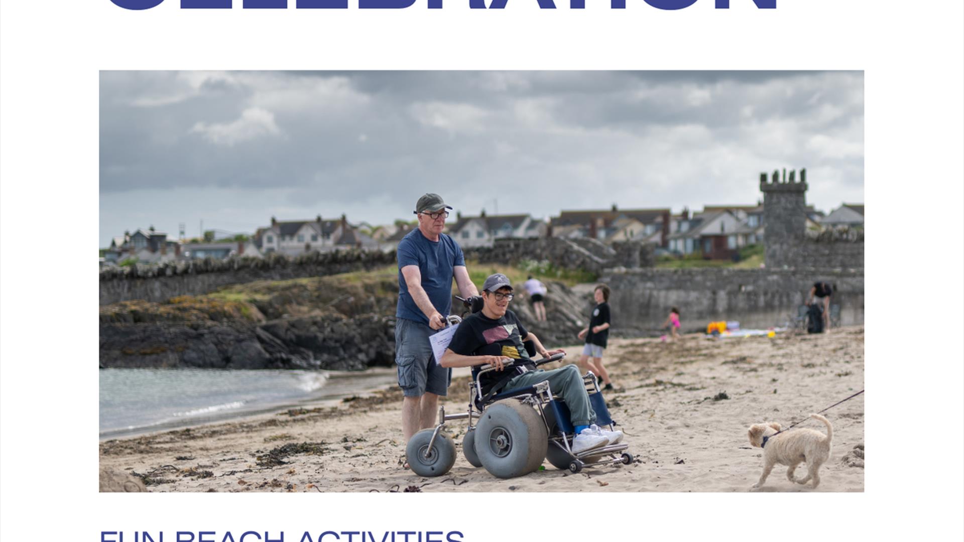 Image showing a young adult on Groomsport Beach seated in an all-terrain beach wheelchair. He is accompanied by a male friend pushing the chair and is
