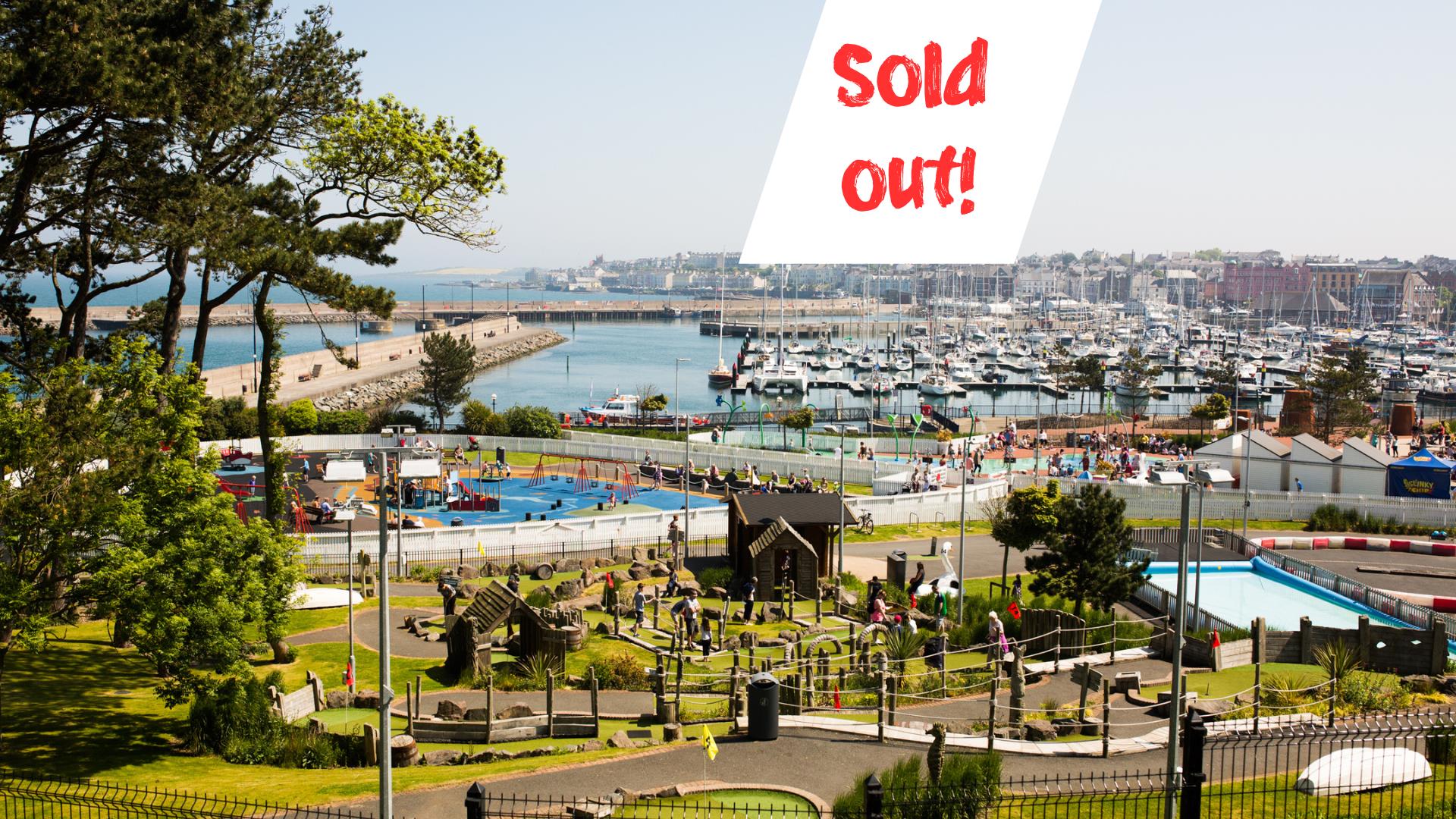 Photo taken on a summers day with a view over Pickie Funpark and the marina with the words 'sold out'