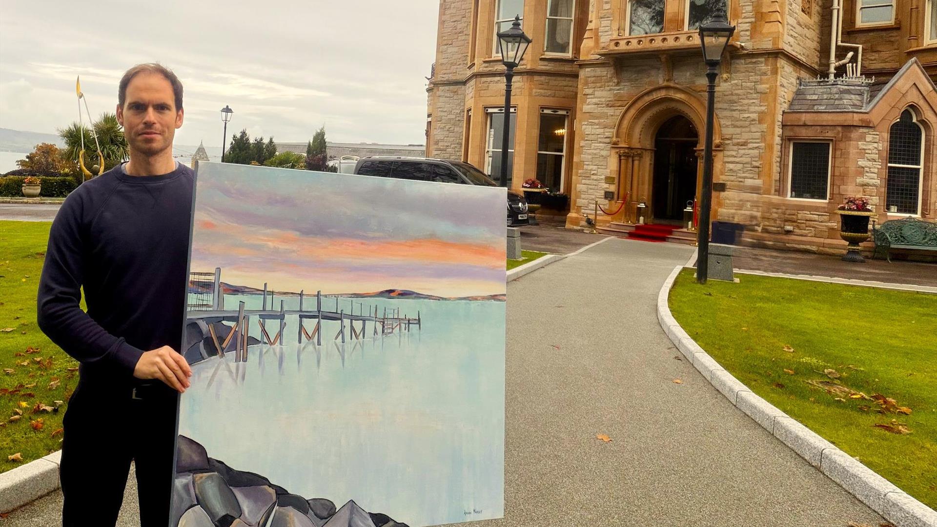 Artist Adrian Margey with his painting 'Calm at Kinnegar'