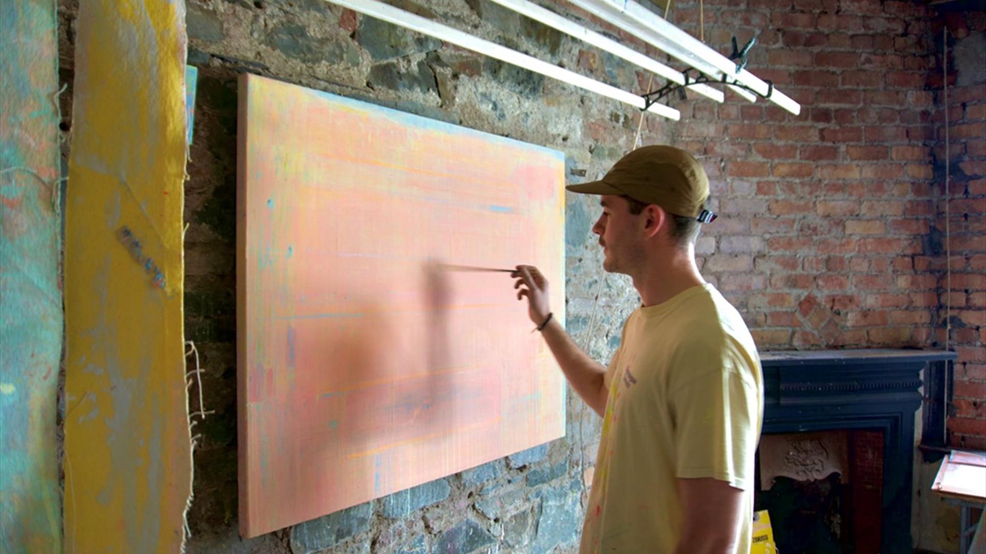 Ross Miley painting on a canvas