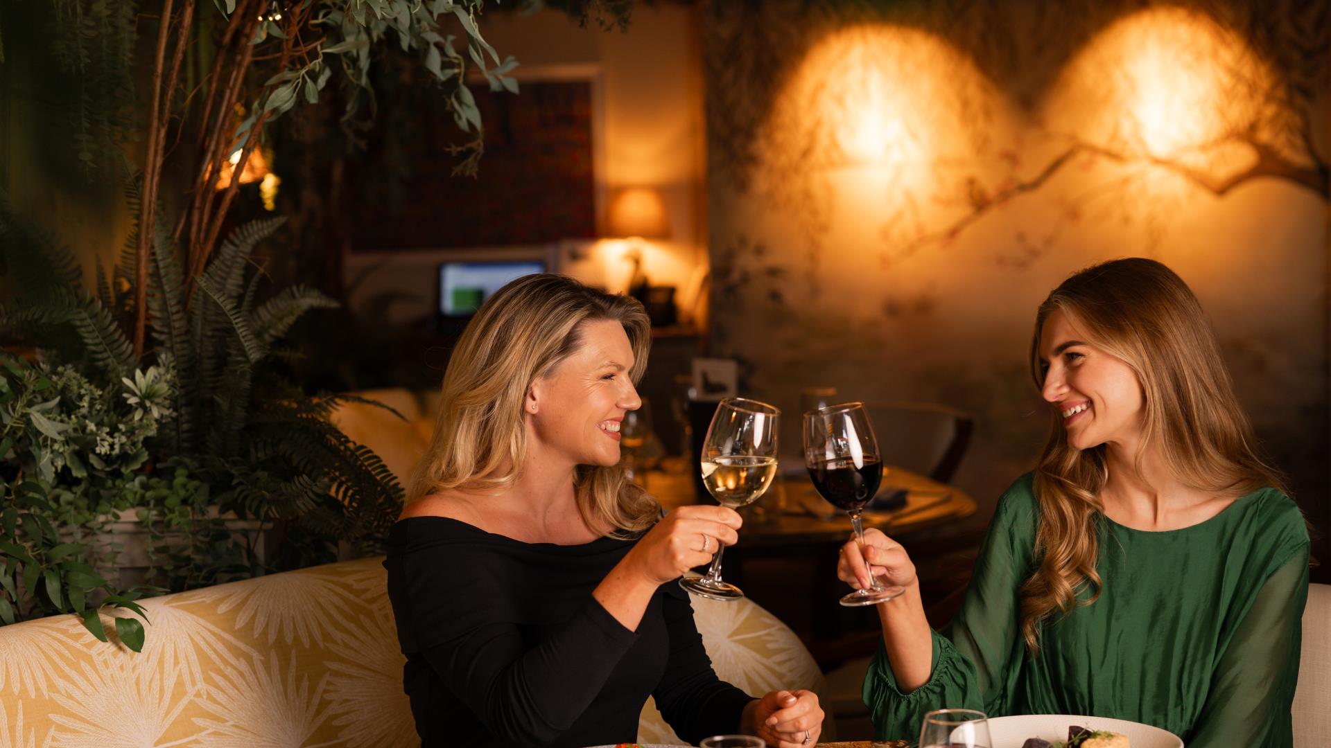 two blonde females at The Old Inn cheering with a red and white wine