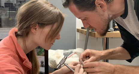 Man and Woman Making Wedding Rings Together