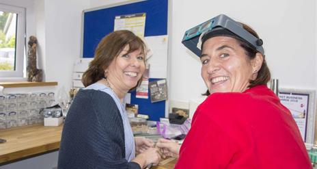 Two happy silver jewellery making women looking towards the camera smiling