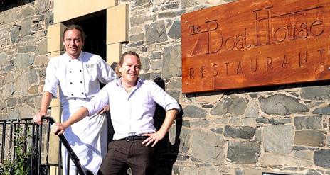 Photo of Jasper and Joery Castel on outside steps of The Boat House