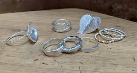 a photo of a selection of silver rings on a table