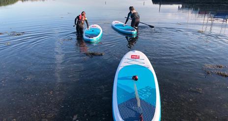 Paddle boarders setting out on the water
