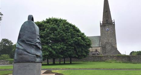 Statue of The Bangor Bell outside of Bangor Abbey in the city