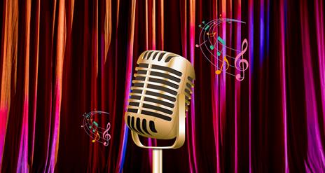 Vintage microphone on stage in front of curtains