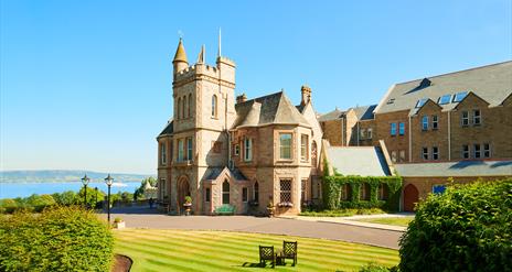 View of the hotel and landscaped grounds on a bright sunny day