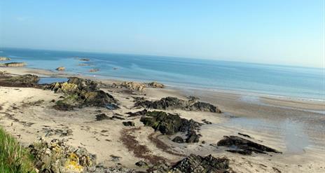 photo of the beach showing the sand and the sea