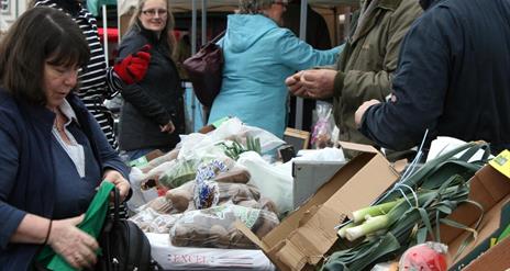Photo of a busy vegetable stall in the market