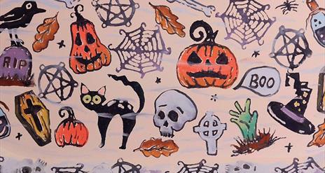 Pottery plate decorated with Halloween themed prints