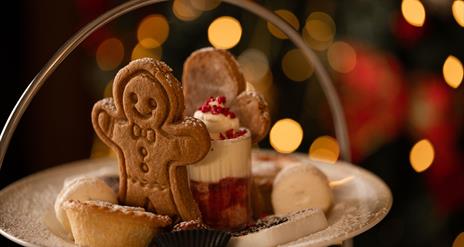Plate with gingerbread person, mince pies and mini trifle