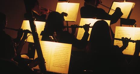 Orchestra players in silhouette