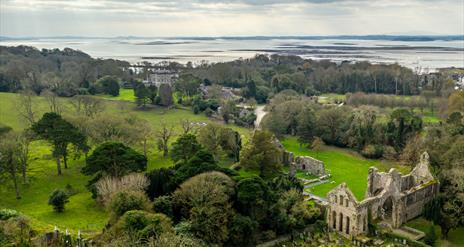Birds eye view of Grey Abbey in Greyabbey with Strangford Lough in the background.