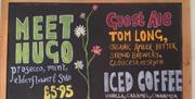 Chalkboard sign promoting different drinks