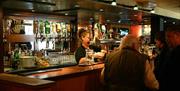 Bar keeper pouring pint