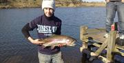 A person holding a large fish