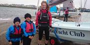 a photo of 3 people standing next to a boat