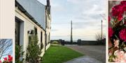 View of The Manse's front lawn and driveway leading toward the sea, with a clear sky and soft light, evoking a peaceful coastal setting.