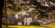Exterior of the Cultra Inn set amongst the leafy grounds of the Culloden Hotel