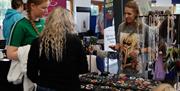 Attendees at HappyFest browsing the stalls in the Exhibition Halls