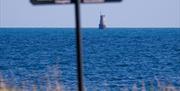 A view of the Black Rock lighthouse out at sea.