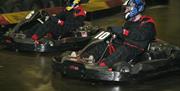 Photo of two competing go kart race drivers